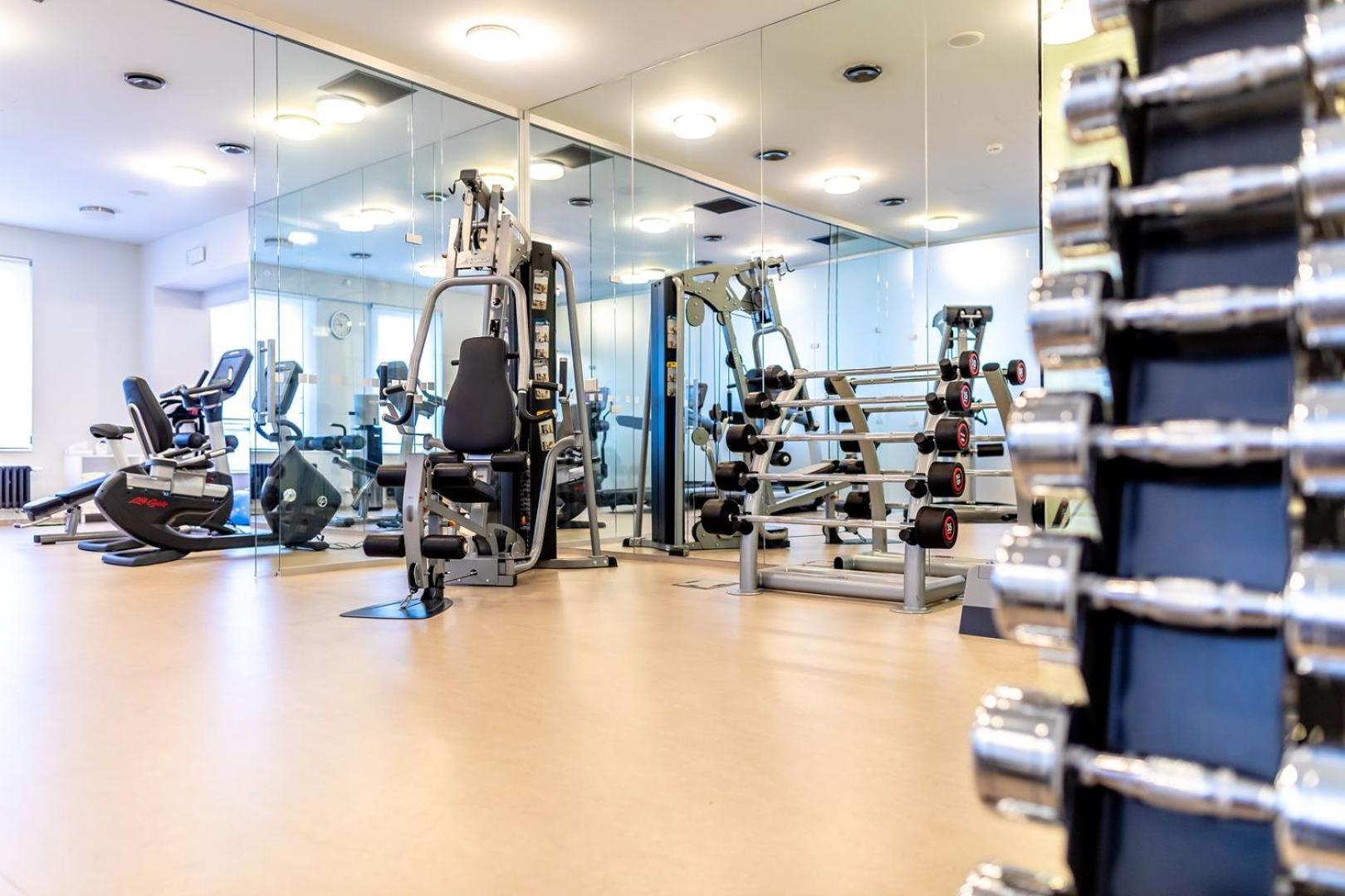 Grandhotel Pupp Karlsbad Buitenkant foto The photo shows an interior view of a gym or fitness center. In the foreground, there is a rack of dumbbells arranged by weight, highlighting strength training equipment. In the background, various exercise machines are visible, including a stationar